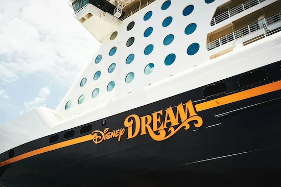 A close-up view of the Disney Dream name across the side of the cruise ship.