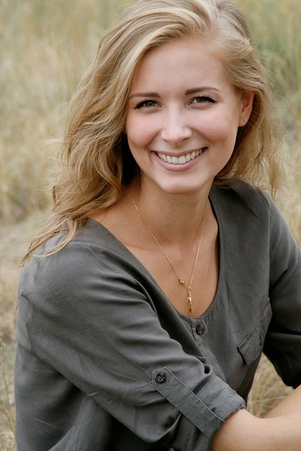 A photo of a woman smiling at the camera.